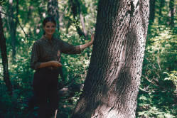 Janet Johnson stand next to the largest green ash tree sampled in W. Carter Johnson's research at #26 in the Garrison Reach of the Missouri River in North Dakota.