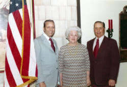 Frank Denholm standing with two constituents at a campaign event.