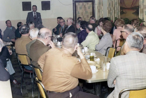 Frank Denholm talking to constituents in a restaurant.