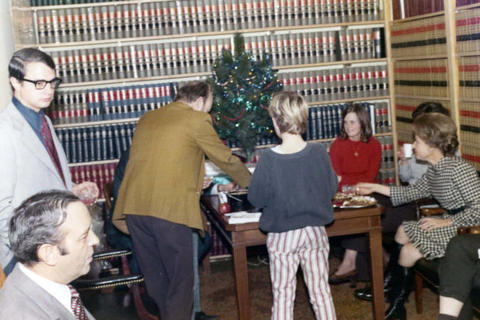 Frank Denholm in his law office for a Christmas party with his staff.