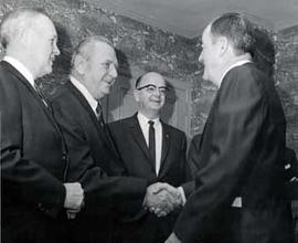 Vice President Hubert Humphrey shakes hands with people