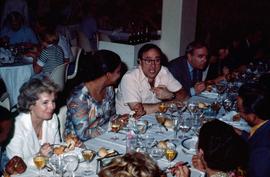James Abourezk talking and dining with others in Cuba