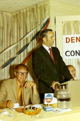 Frank Denholm standing at a podium during a campaign event.