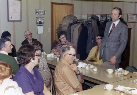 Frank Denholm speaking with a group of constituents.