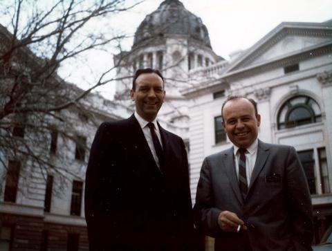 Frank Denholm and a man standing by the capital building in Pierre, South Dakota.