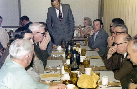 Frank Denholm is speaking to constituents in a restaurant.