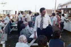 Frank Denholm is mingling with constituents at an outdoor event.