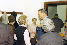 Frank Denholm speaking with voters at a campaign event.
