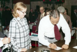 Frank Denholm signing an autograph for an admirer at a campaign event.