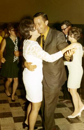 Richard Kneip is dancing with a woman at a campaign event.