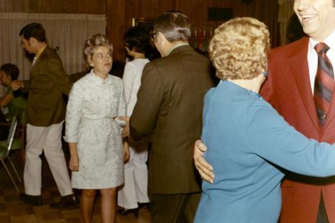 Frank Denholm dancing with a woman a celebration in his honor for winning the Senate race in 1970 and celebrating his birthday Others in the room also dancing.