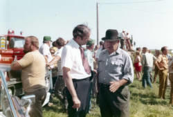 Frank Denholm talking with a constituent at an outdoor event.