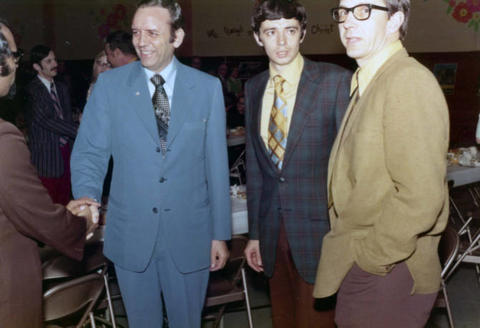 Frank Denholm greeting constituents at a luncheon event.