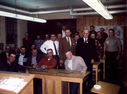 Frank Denholm with a large group of people at an event.