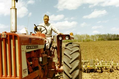 Frank Denholm sitting on an International Farmall tractor during his 1970 campaign