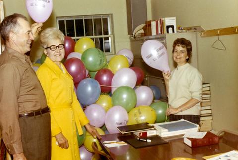 Millie Denholm is working with campaign volunteers. There are balloons on a table Elect Frank Denholm for U.S. Congress.