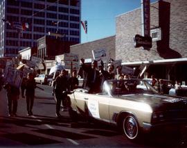 Frank Denholm and his wife, Millie, are riding in a convertible in a parade during his 1968 campaign for Congress.