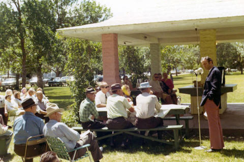 Frank Denholm speaking at constituents at an event held in a picnic shelter.